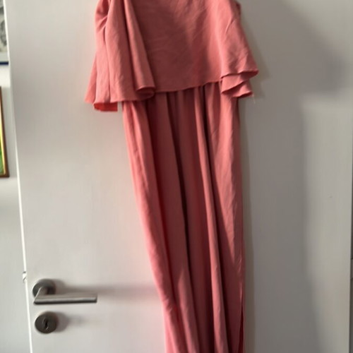 One-piece jumpsuit size S, like new, with ruffles and side openings