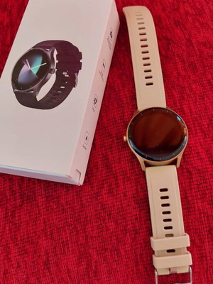 Smart watch, gold with beige strap and black with extra straps