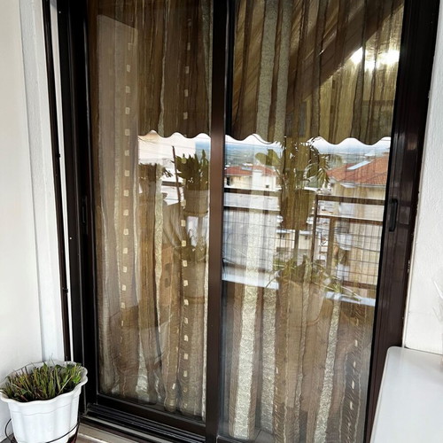 Aluminum sliding windows with dark brown shutters and screens used, set of multiple pieces