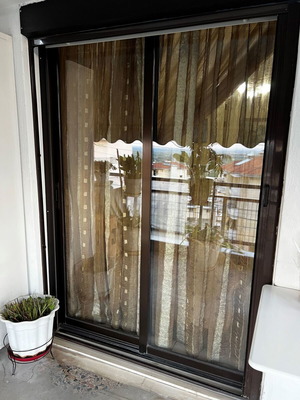 Aluminum sliding windows with dark brown shutters and screens used, set of multiple pieces