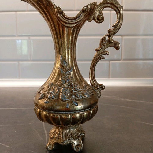 Metal container used with embossed design and handle