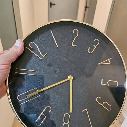 Wall clock like new with black dial and gold hands