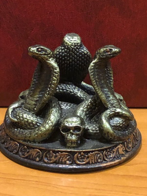 Decorative figurine with snakes and skulls