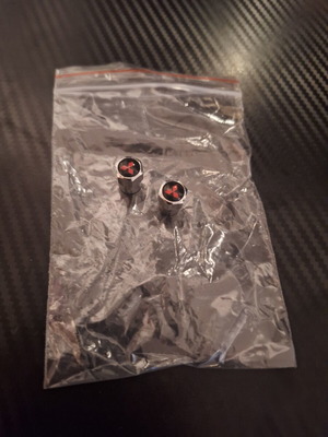 Mitsubishi valve caps like new, silver with black and red detail, set of 2