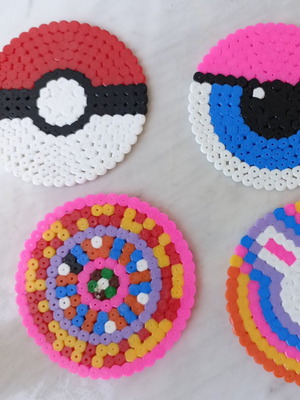 Set of 4 handmade fuse-bead coasters with colorful pixel designs