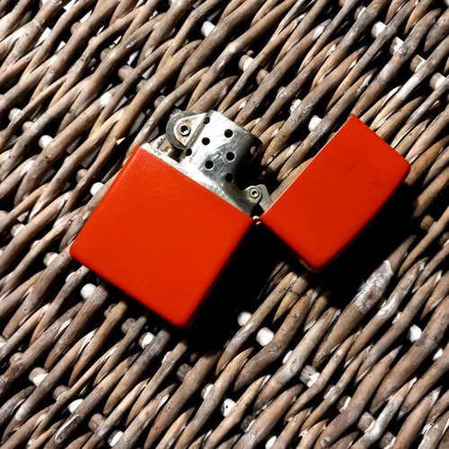 Zippo lighter used, large bright red
