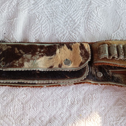 Vintage leather belt with cartridge and pistol holster used