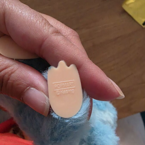 Labubu doll with car seat attachment