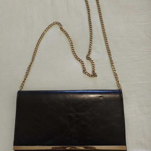Black clutch bag with gold chain used, synthetic leather