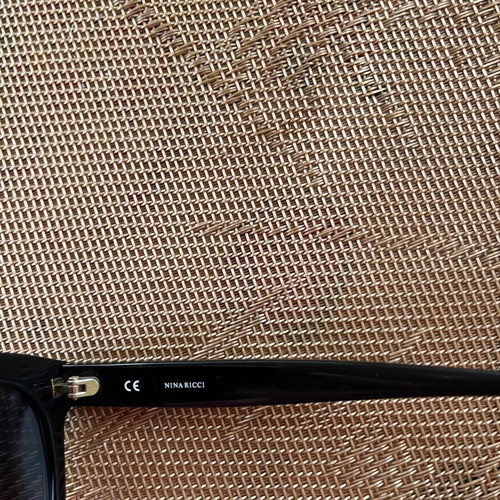 Nina Ricci SNR097 sunglasses like new, black oval acetate frame with chain design