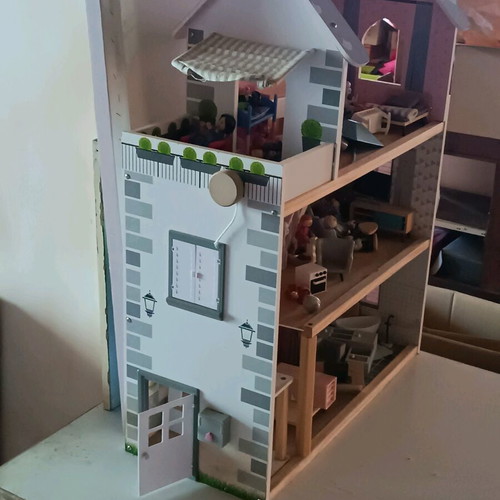 Wooden dollhouse used with extra accessories pack