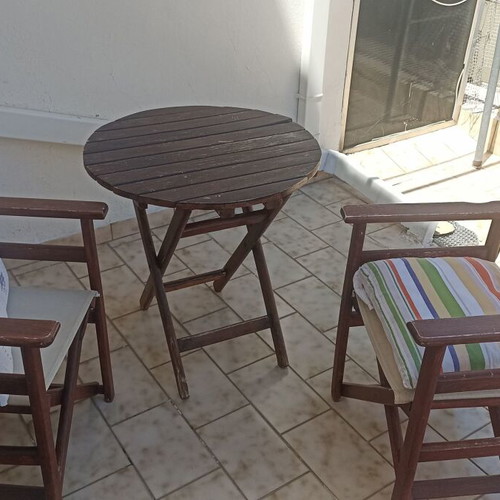 Wooden balcony set with table and two chairs used