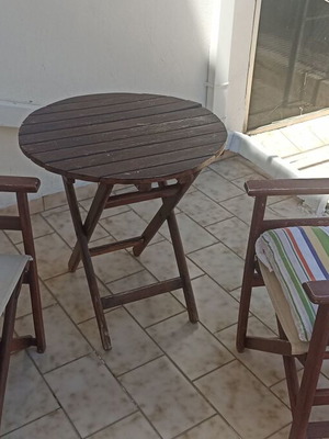 Wooden balcony set with table and two chairs used