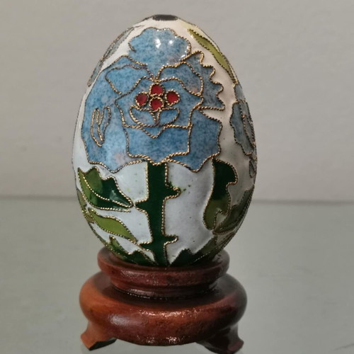Cloisonne egg used with blue flowers and wooden base