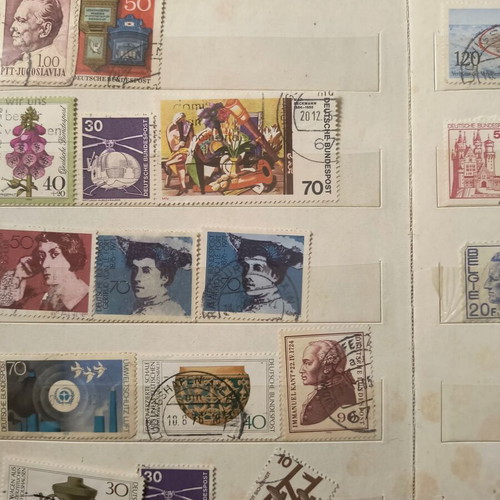 Stamp album like new with about 500 mostly foreign stamps