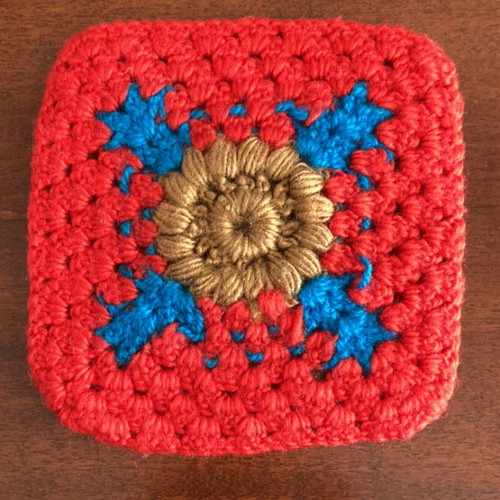 Square wool pot mat hand-knitted like new, red, blue and gold