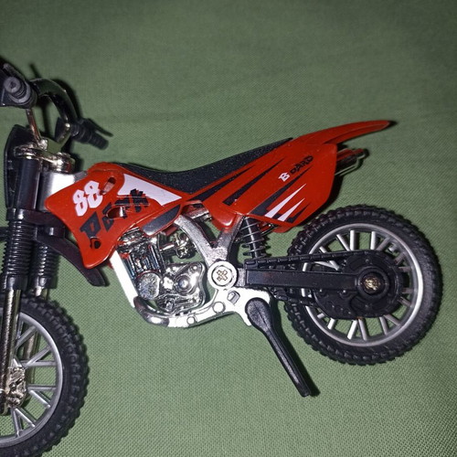Motocross toy miniature new with extra wheels and nuts