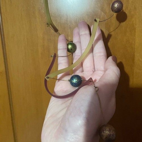 Long necklace used with gold-plated multicolor beads and plastic parts