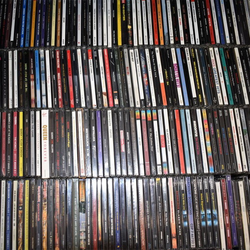 Music collection of 360 rock, pop, metal CDs, 29 music DVDs, 2 VHS tapes, with 2 CD shelves