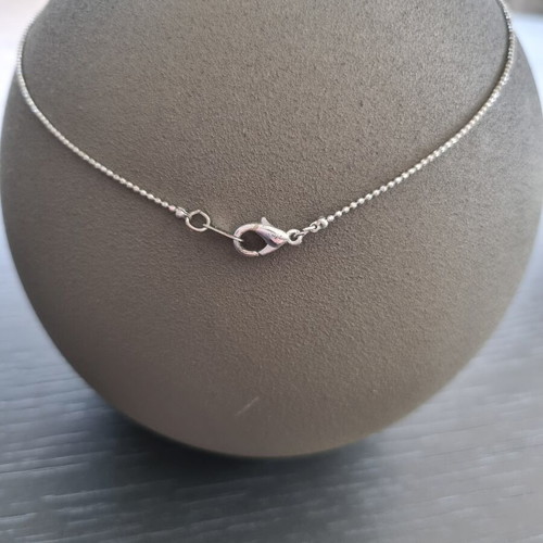 Necklace with hanging chain and stones
