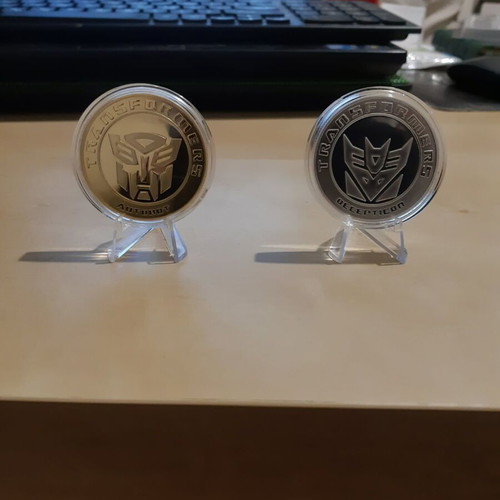 Transformers metal coins new, set with acrylic case and stand