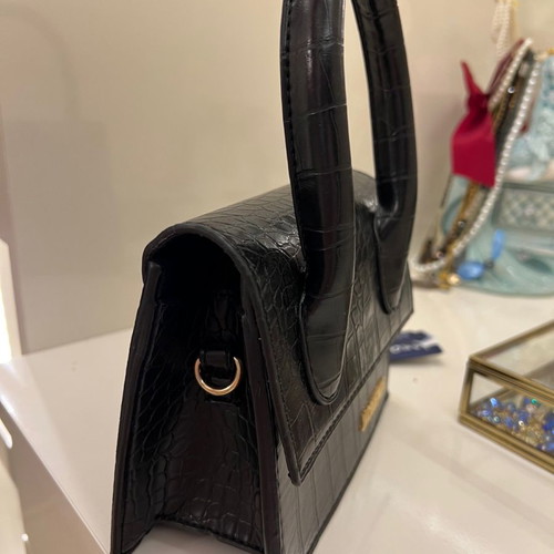 Small black handbag used with strap inside