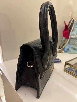 Small black handbag used with strap inside