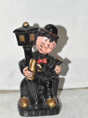 Vintage ceramic decorative figure used with gentleman and street lamp