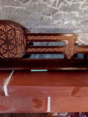 Traditional woodcarving decoration used, small etagere with rosette motif
