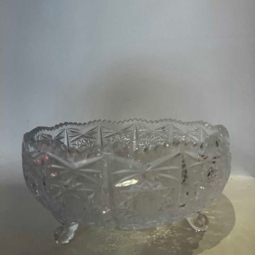 Vintage crystal bowl with feet and embossed carved designs, used