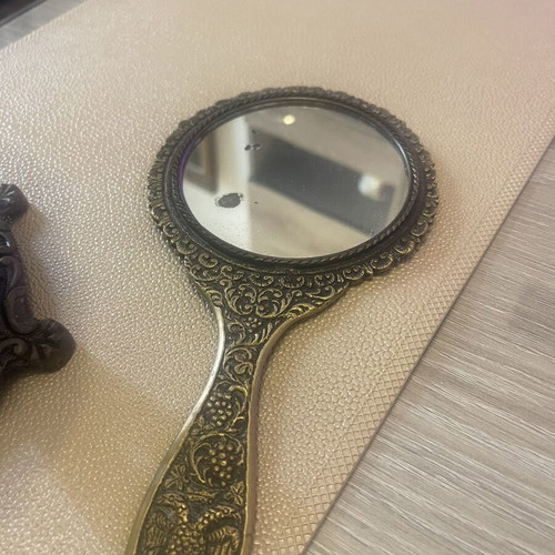 Set of two brass mirrors, table and hand used