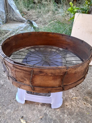 Handmade antique sieve with wooden frame and metal mesh
