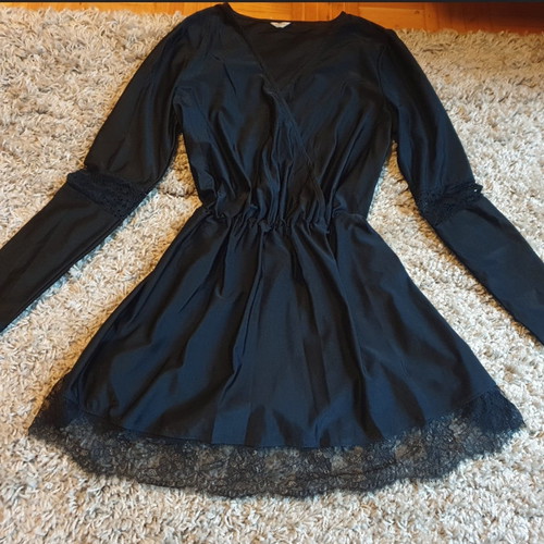 Black crossover dress used with delicate lace trim