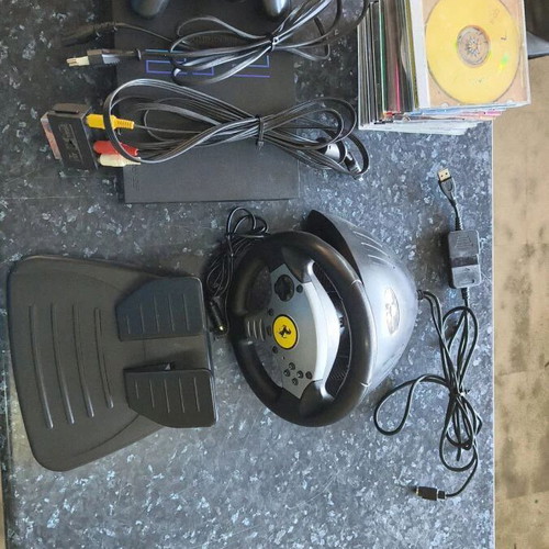 Sony PlayStation 2 console used with Thrustmaster racing wheel and accessories