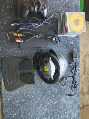 Sony PlayStation 2 console used with Thrustmaster racing wheel and accessories