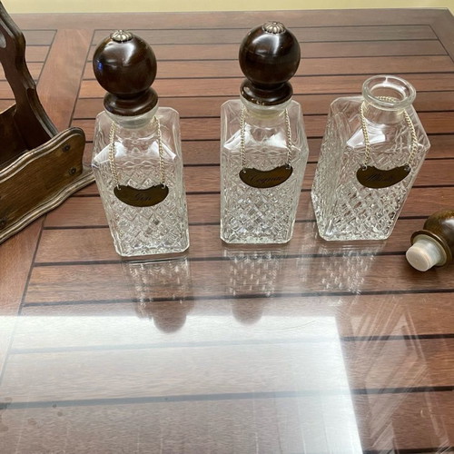 Vintage English decanters used in wooden stand for gin, cognac, whisky