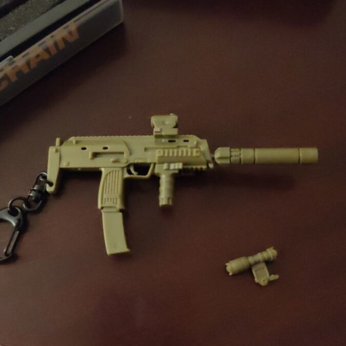 Set of various keychains with gun, drill and ribbon, unused