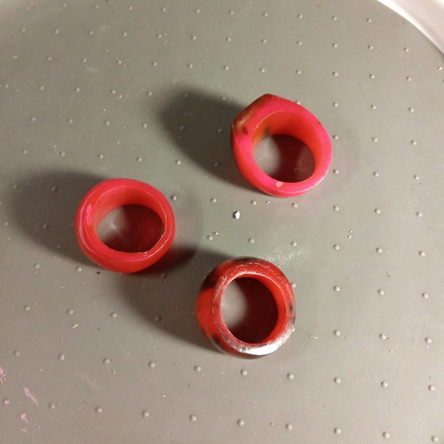 Three fuchsia celluloid rings like new, sizes 8.5, 8.75 and 7.5