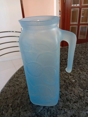 Glass pitcher blue with embossed design like new