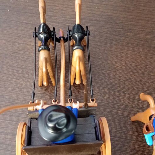Playmobil Western toy with curved pole between horses