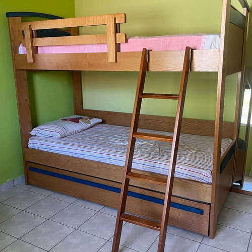 Wooden bunk bed with third sliding bed and mattresses like new