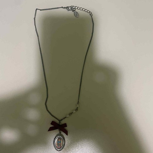 Pendant used with silver chain, pearls and retro bow