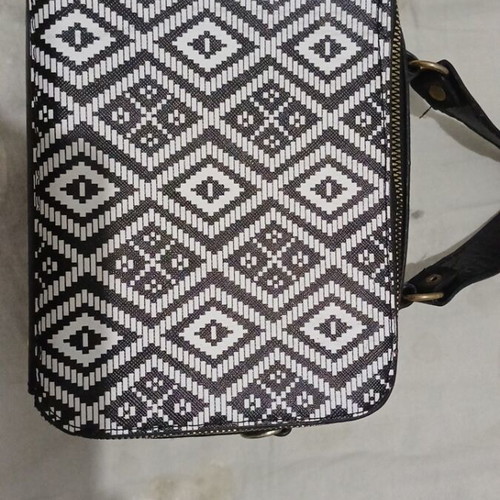 Black and white handbag with dual zipper and spacious interior