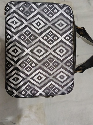 Black and white handbag with dual zipper and spacious interior
