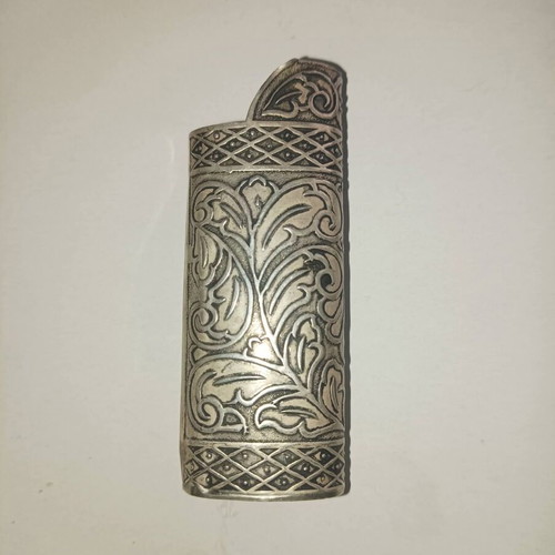 Vintage silver lighter case used with carved floral patterns