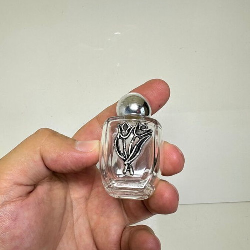 Vintage glass perfume bottle with metal tulip decoration