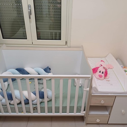 Baby crib like new with integrated changing table and storage space