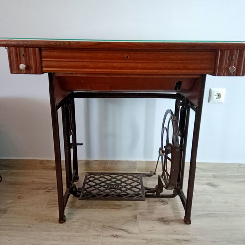 Antique sewing machine used with furniture and accessories