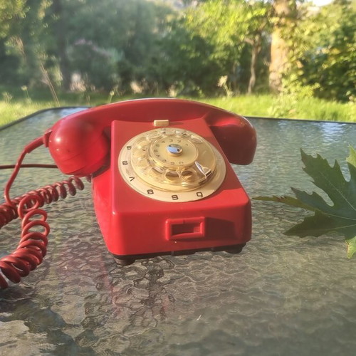 Vintage red wired telephone used