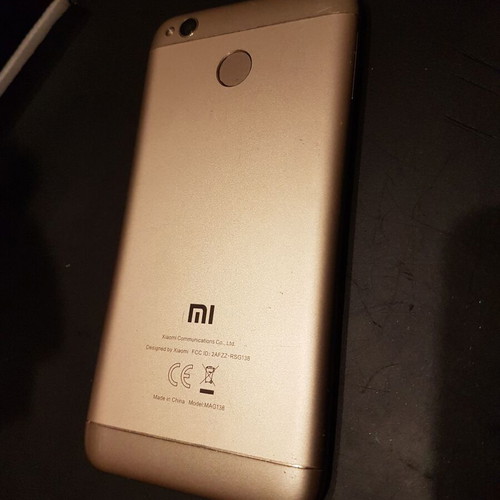 Xiaomi Redmi 4X smartphone with cracked screen, gold